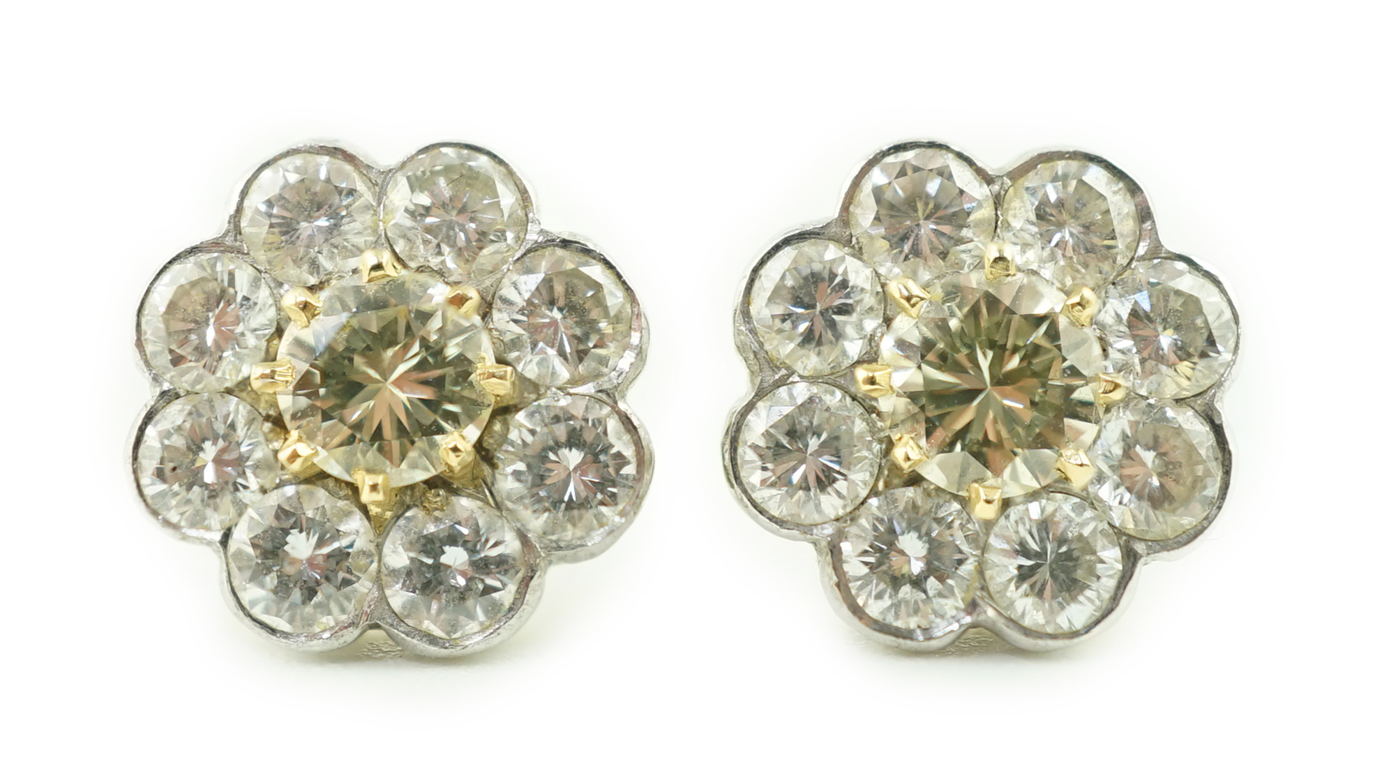 A pair of gold and nine stone diamond cluster set flower head ear studs